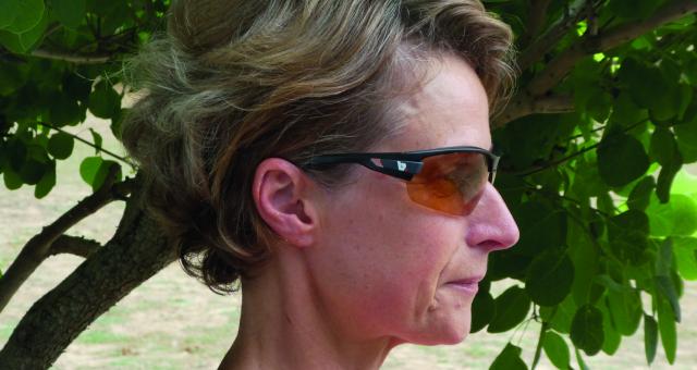 A woman's profile showcases a pair of sunglasses