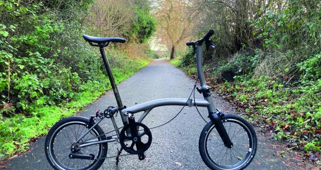 A foldable bicycle stands on a cycle path